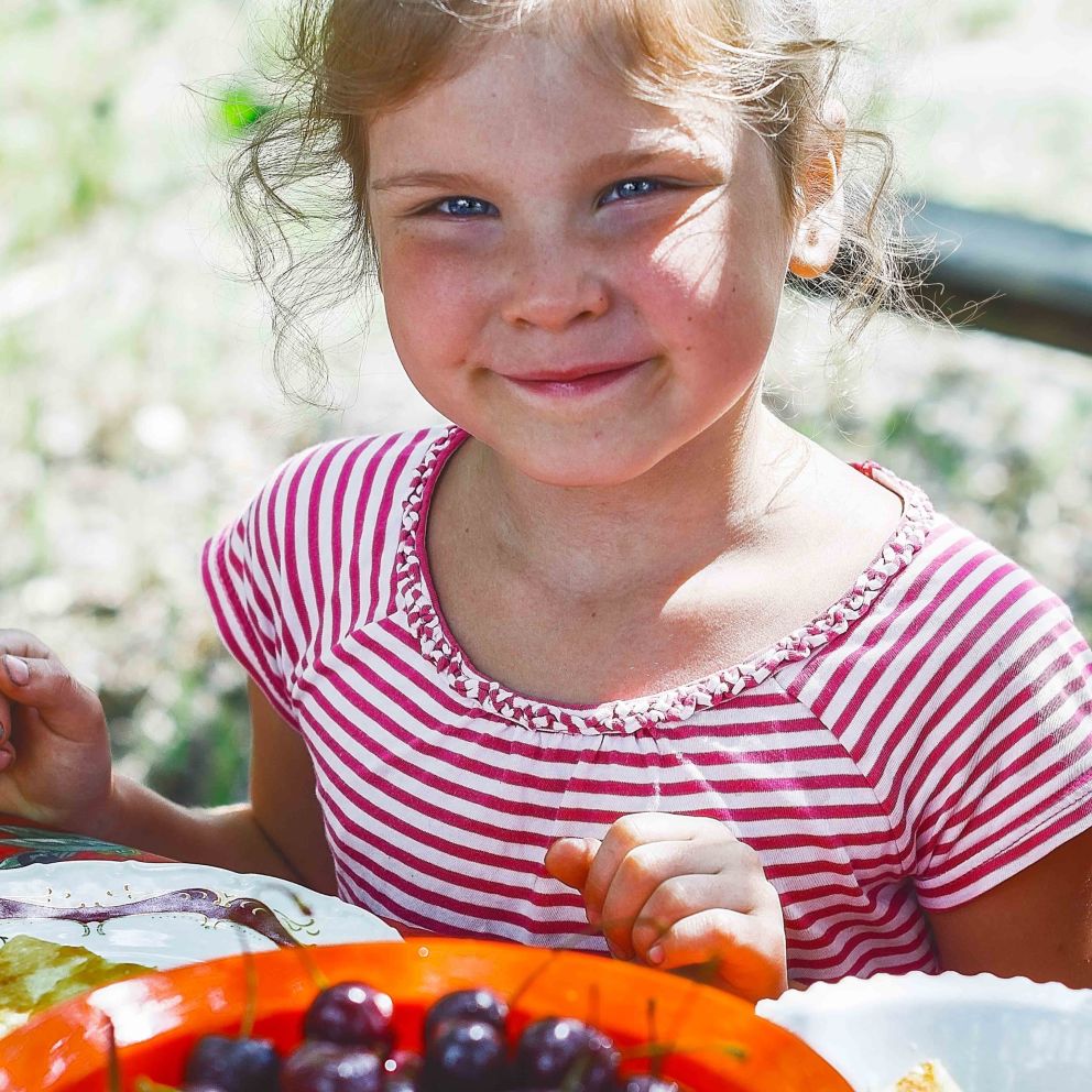 Pandemics in Canada - smiling-girl-at-picnic-table